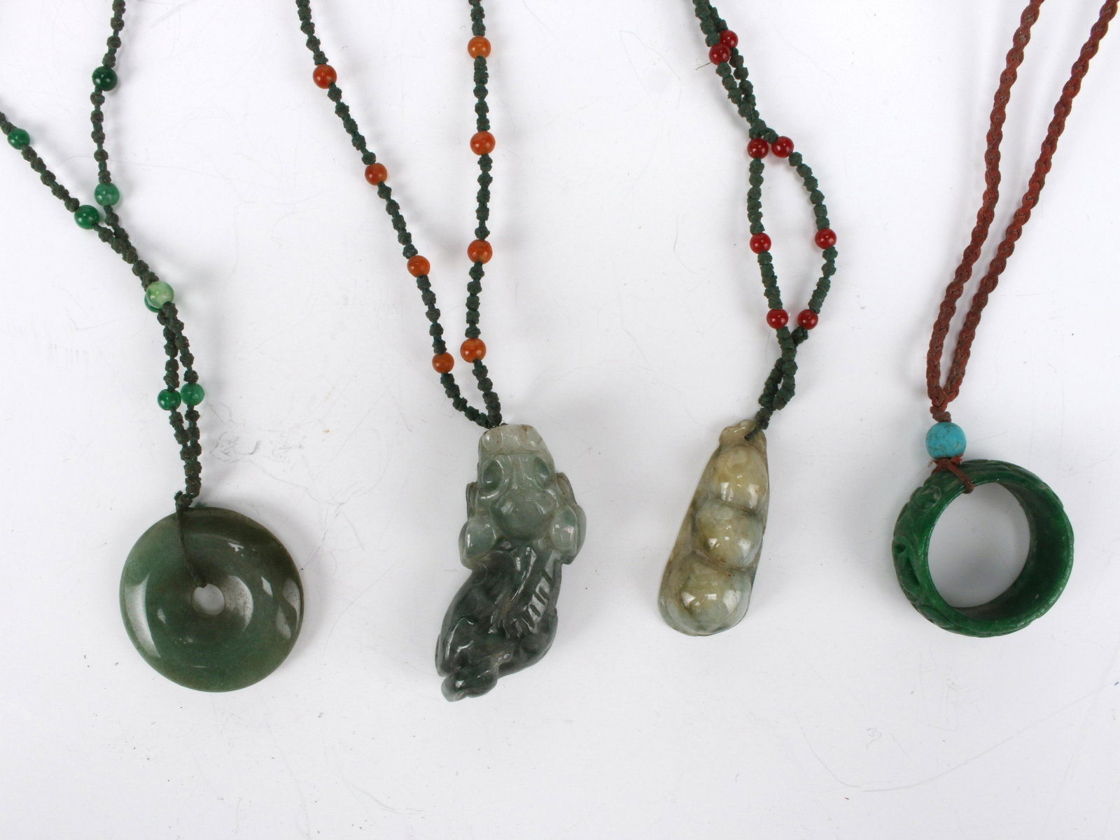 FOUR JADE PENDANTS (1 of 3)
