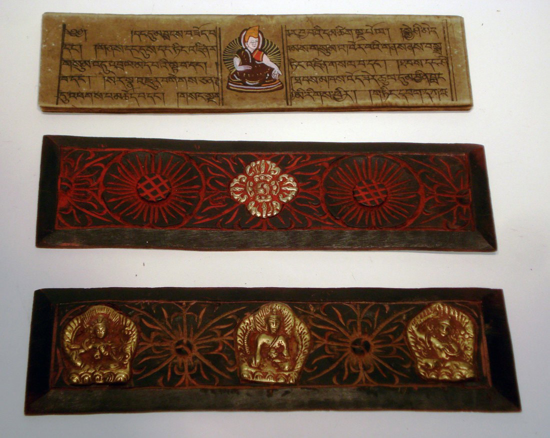 Buddhist Manuscript: A 19th century Buddhist 10 page hand lettered manuscript with each page having a central hand painted Buddha image and enclosed by two gilt and red paint decorated carved wood binders featuring inside