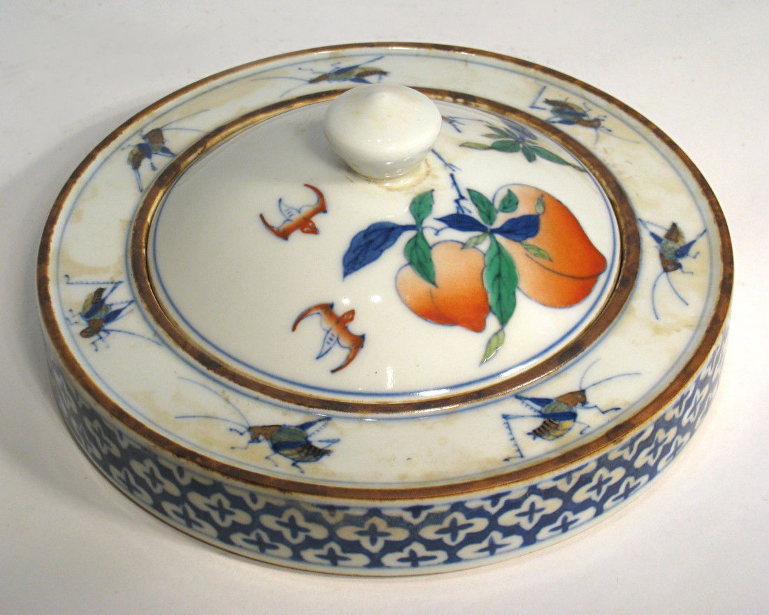 Interesting Porcelain Inking Jar: A lidded porcelain ink jar with the lid having peaches and bats in glaze with grasshoppers encircling the rim. Five color glazes with a six character mark on the bottom. About 7". Shipping: We are abl