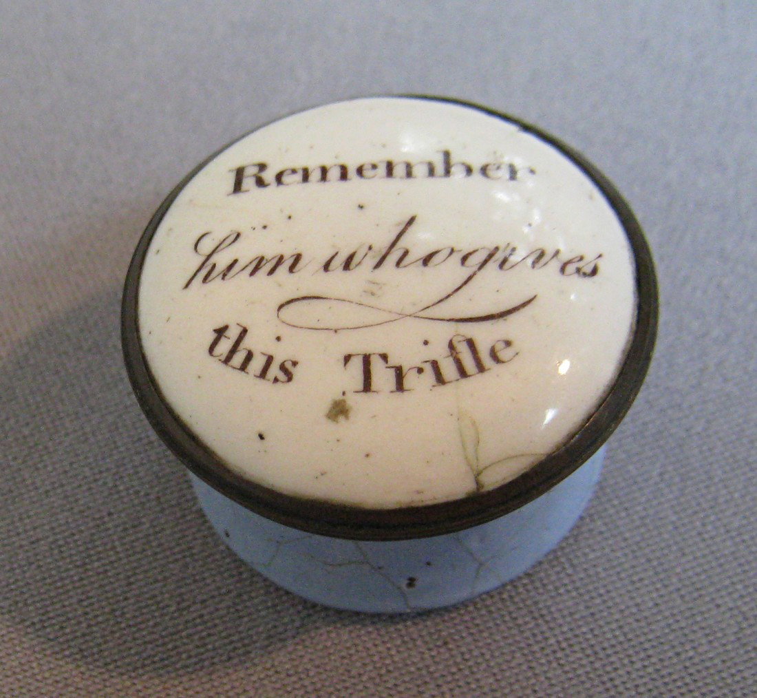 Bilston Box: A 32 mm round Bilston patch box in enamel with the sentiment: "Remember him who gives this trifle". Some damage to the bottom rim of the container, while the lid has only a minor short hairline at the