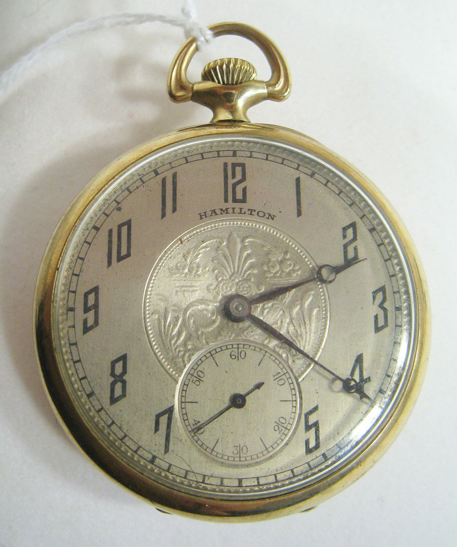 Hamilton Model 910 Dress Watch: In a 45mm open faced gold filled case , the 17 Jewel movement numbered 1977486. Shipping: We are able to pack and ship this item to an address in the United States for $15.00 via USPS Priority Mail. T