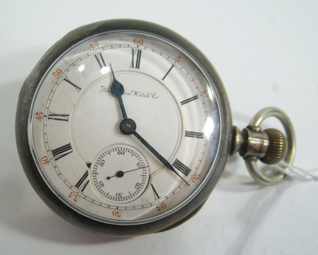 Hampden "Railway" Watch : An 18 size pocketwatch within a coin silver case, 55 mm, having a 15 jewel movement #199754.The dial with a chip in the inner ring at about 7:00. The watch may run with only cleaning. Shipping: We are