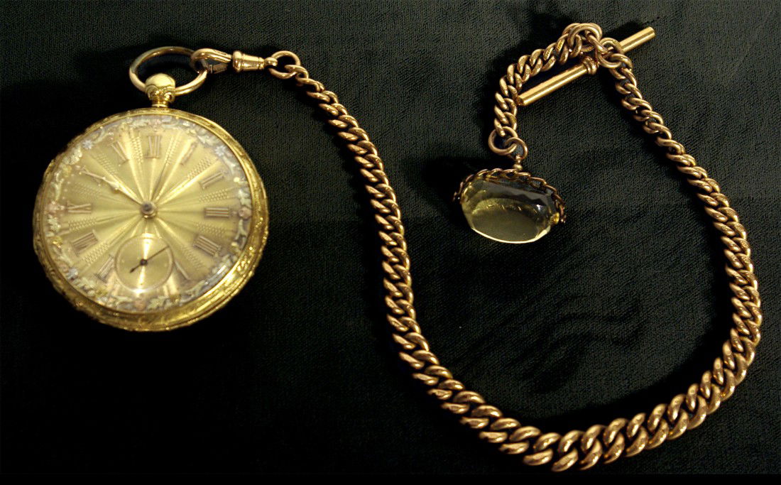 Gold Watch, Chain and Fob: An engraved 55 mm open faced 14 or 18K gold watch from the first half of the 19th century signed "M. I. Tobias" of the Liverpool school, featuring a fusee, detached lever escapement, multicolored gold
