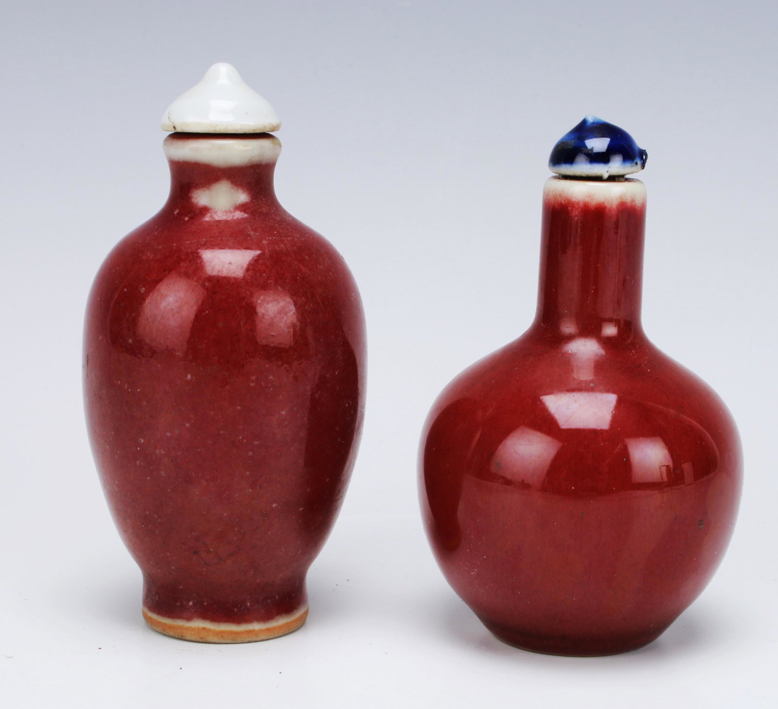 TWO OXBLOOD SNUFF BOTTLES: TWO OXBLOOD SNUFF BOTTLES </