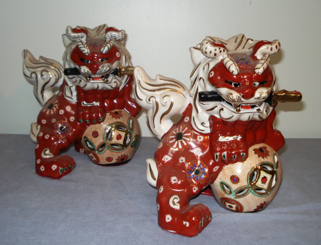 Two Ceramic Foo Dogs: Two, in iron oxide red and other glazes, with each about 10" in height. Shipping: We are able to pack and ship this item to an address in the United States for $40.00 via USPS Priority Mail or via Fed
