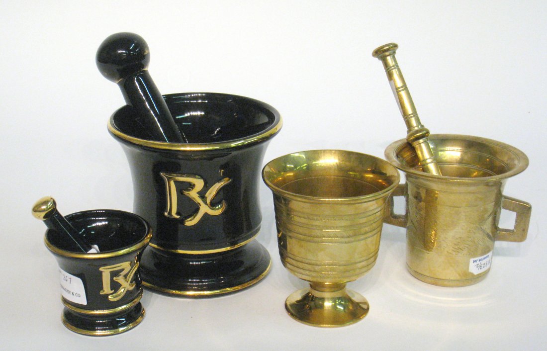 Four Mortar And Pestle Items: Two brass examples, both considered antique, 4 3/4" in height and 4 1/2" . Then two dark blue and luster gold mortar & pestles, at 5 3/4" and 3 1/4". These together with two brass napkin rings. Shippi