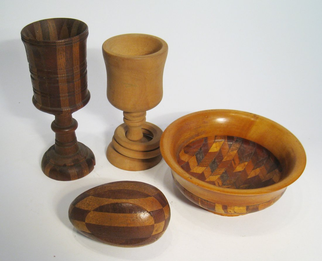 Treen Ware Items: A group of treen ware items The 5" bowl signed "A. M. Stickle"; the egg with a small missing sliver; The goblet with rings unpainted and another goblet. Four items. Shipping: We are able to pack and s