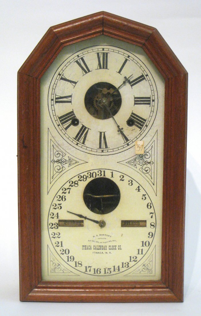 Calendar Clock: A walnut cased 19th Century American calendar clock by Ithaca with a double dial featuring Horten's Patent. Shipping: We are able to pack and ship this item to an address in the eastern states for $50