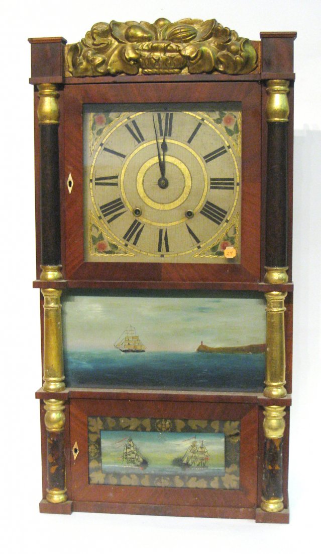 Triple Deck Shelf Clock: An early 19th century shelf clock with reverse painted glasses (later re-done), gold leaf original crest and column capitals, and mahogany veneer case. Lacking feet. Shipping: We are unable to ship th