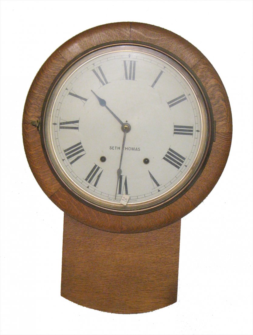 Wall Clock By Seth Thomas: Oak cased, 22" in height. Shipping: We are able to pack and ship this item to an address in the eastern states for $50.00 or to the western states for $80.00 via USPS Priority Mail or via FedEx Ground