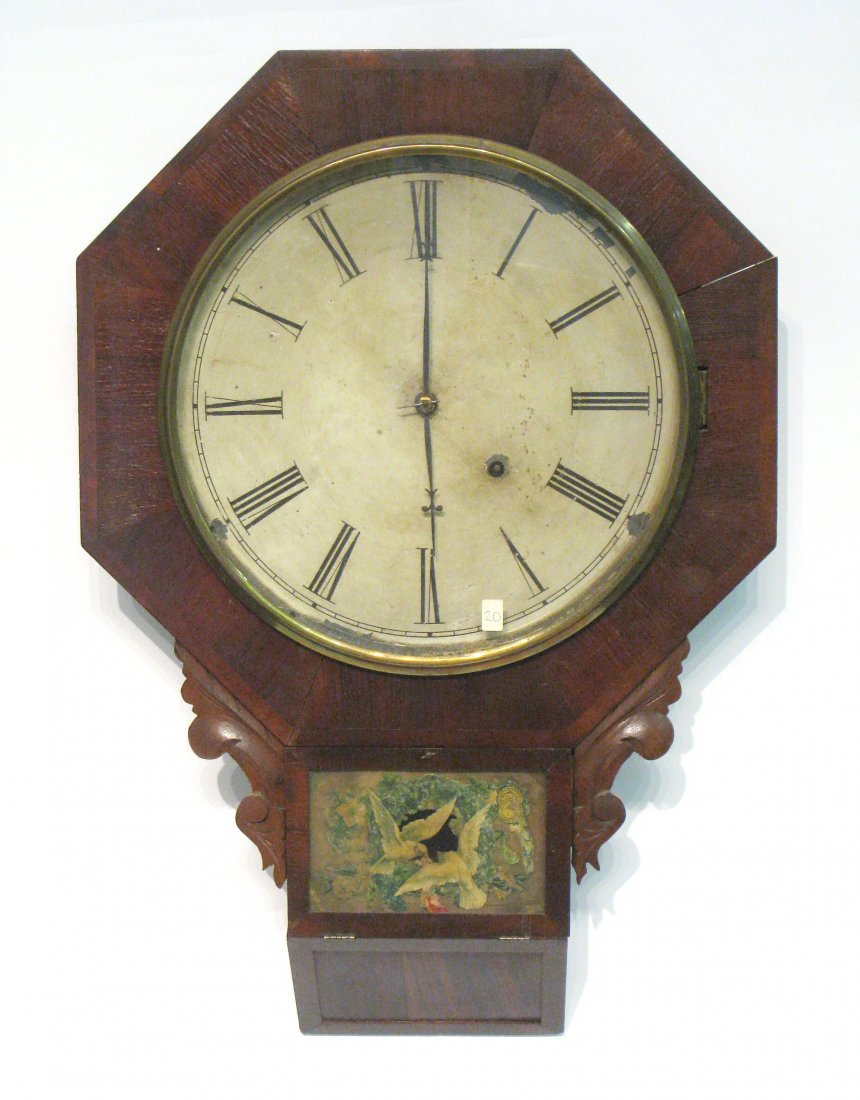 A Wall Timepiece: An earlier 19th century American wall timepiece labeled as by the Forrestville Clock Company with pendulum escapement and spring drive for eight days. Shipping: We are able to pack and ship this item 