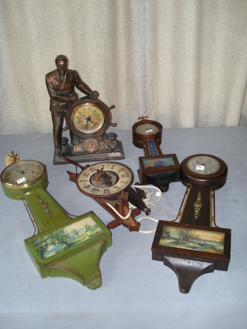 Five Clocks, Including Three Banjo Clocks: Three banjo clock, all or 20th century origin, with two other collectable examples. Shipping: We are able to pack and ship this item to an address in the United States for $55.00 via USPS Priority Mai