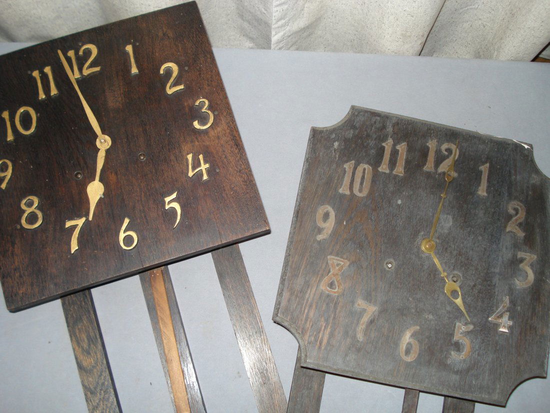 Two Mission Style Wall Clocks: Each one in oak fume with applied Arabic numerals. Ca 1900. No pendulums. Shipping: We are unable to ship this item. Please contact our local UPS Store, store1152@theupsstore.com, for a quote. Please