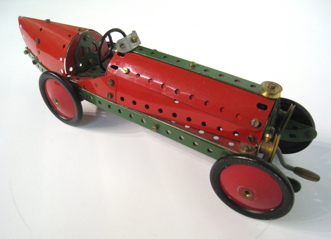 Erector Set Type Race Car: A green and red race car made from erector set components. 14" long. Shipping: We are able to pack and ship this item to an address in the United States for $50.00 via USPS Priority Mail or via FedEx 