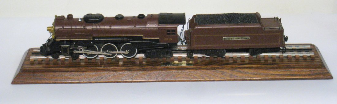 Model Lionel Train On Tracks: A 25 1/2" long model train, apparently wired with motor, etc., but for display, mounted on a display board with track. Made by Lionel. Shipping: We are unable to ship this item. Please contact our loc