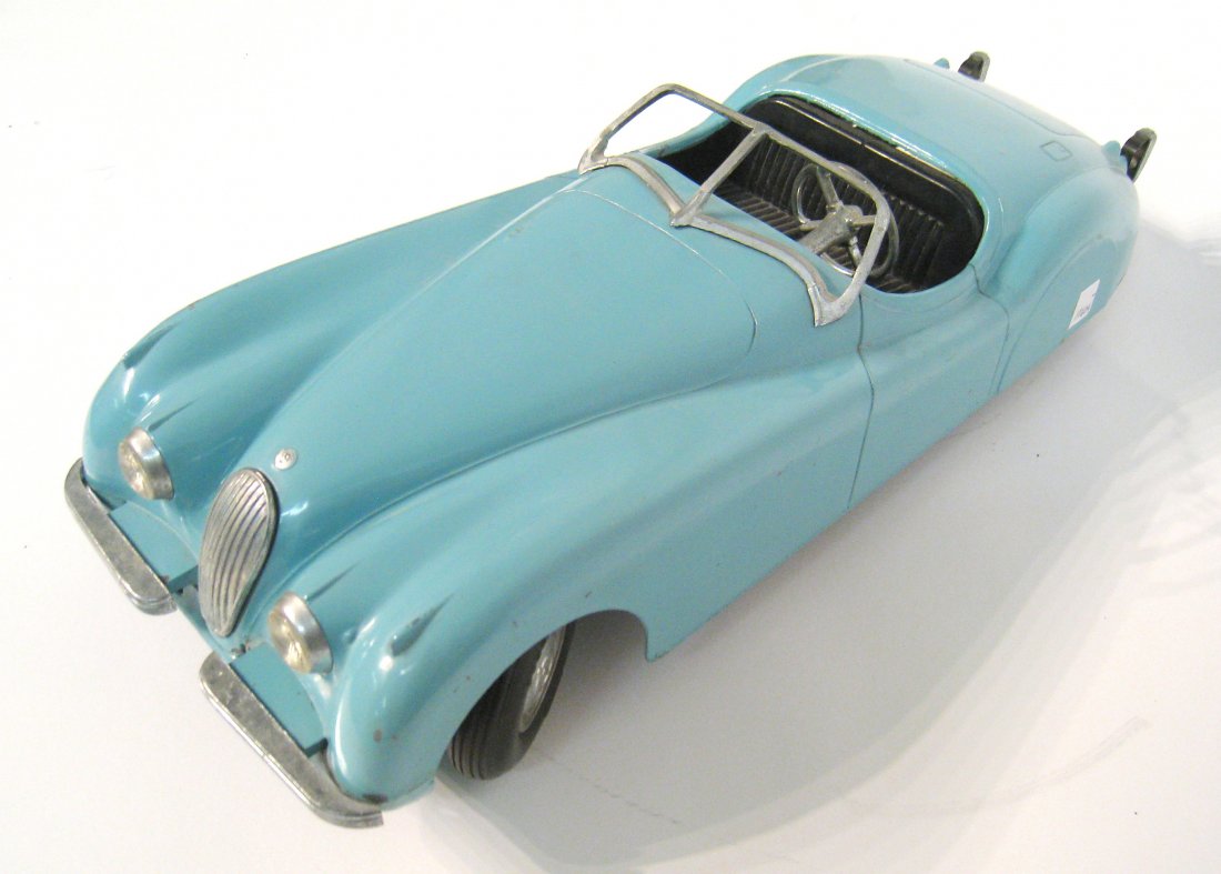 Model Jaguar convertible, "Mossmoyke original": A light blue painted metal model of a Jaguar sports car, 17 1/2" in length Embossed with the word Mossmoyke. . Shipping: We are able to pack and ship this item to an address in the United States for $