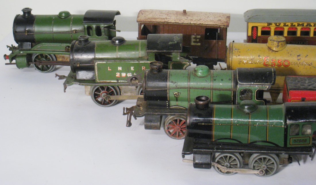 13 Hornby Type Train: Includes four wind-up lithographic decorated locomotives and various other cars associated with the same gauge. Shipping: We are able to pack and ship this item to an address in the United States for 