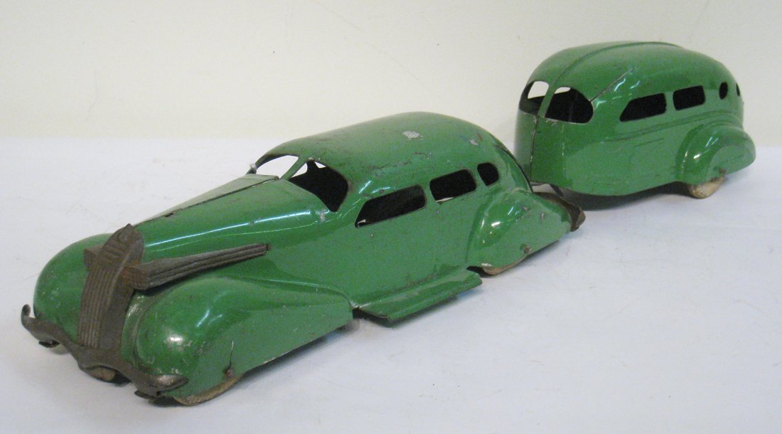 A Green Sedan And Trailer: A toy car/trailer combination. A green "Wyandette" LaSalle automobile in original paint towing a matching trailer. The rubber tires are in poor condition. Shipping: We are able to pack and ship this i