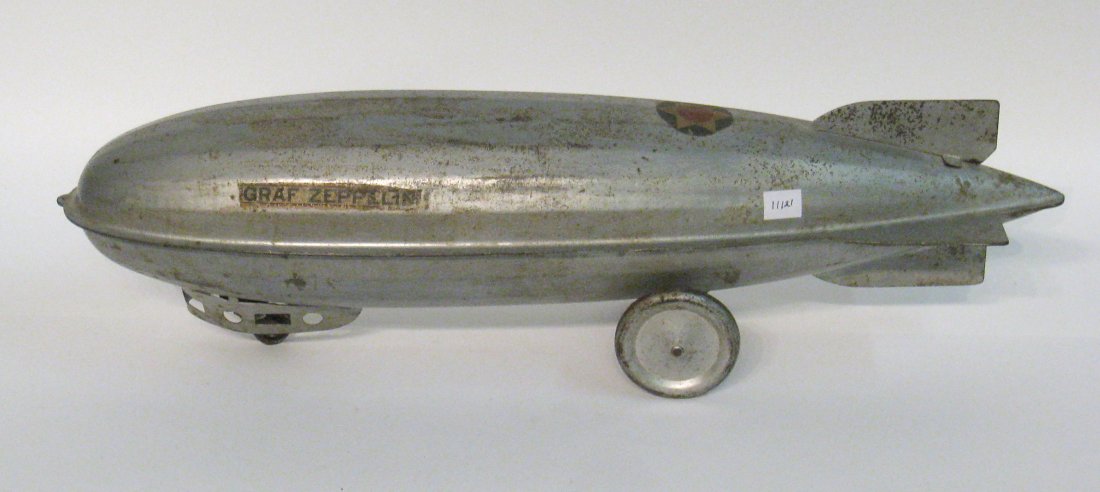 A Model Graf Zeppalin Pull Toy.: In fair condition with some rust effervescing and a curious U S Army Air Corps symbol atop this German made dirigible. Shipping: We are able to pack and ship this item to an address in the United Stat