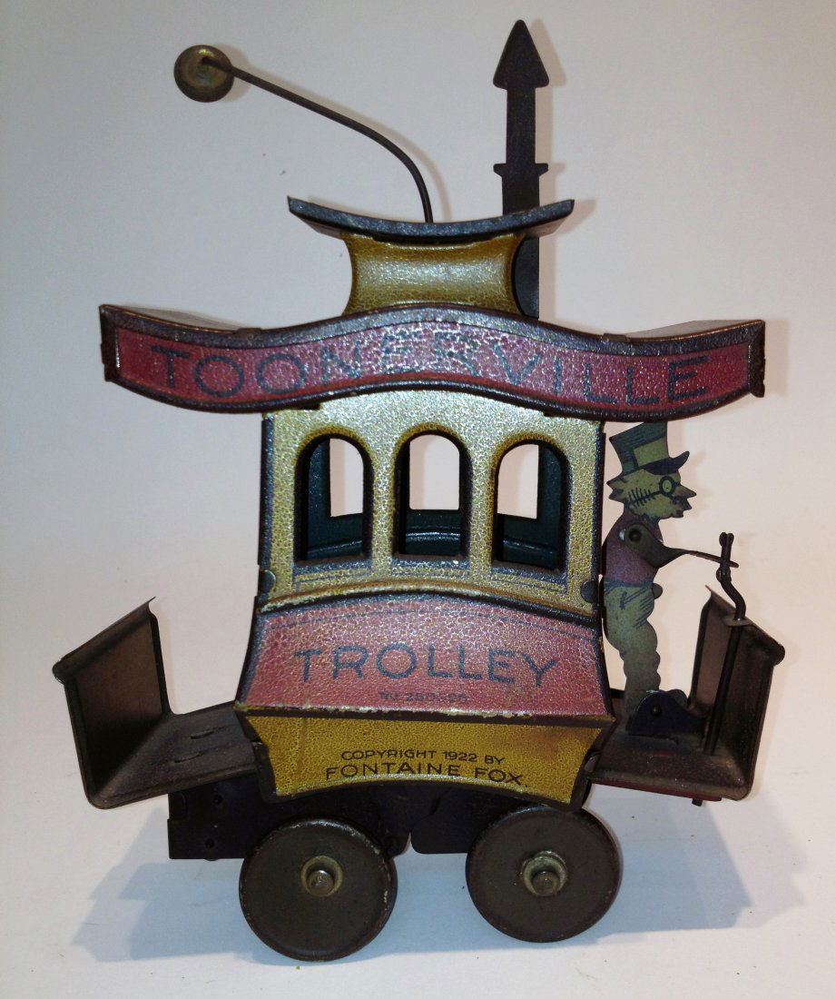 Toonerville Trolley Toy: A 7 1/2" tin and paint decorated wind up trolley "Copyright 1922 by Fountaine Fox". Paint has faded and a little discolored, but in excellent condition otherwise; wind up function works although the c