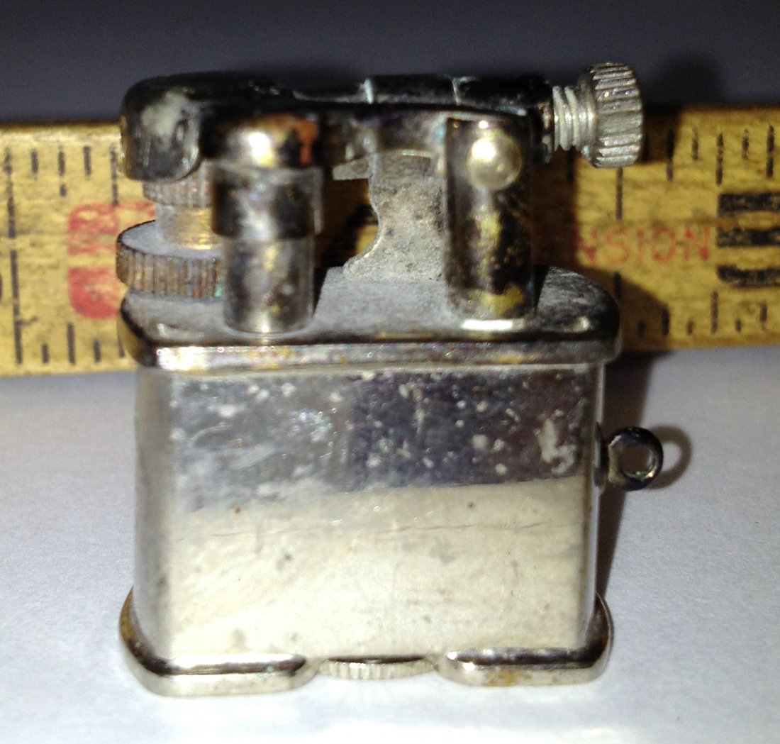 Golden Wheel Cigarette Lighter: "Worlds smallest lighter!" About 1" tall. This may work, although there seems to be no flint and of course our of fluid. Shipping: We are able to pack and ship this item to an address in the United St