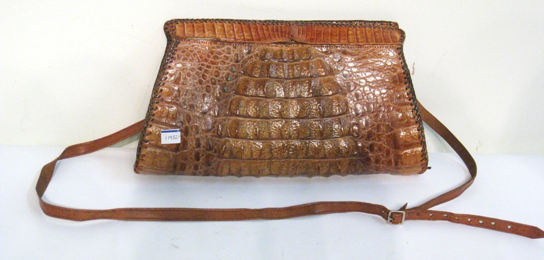 Crocodile Skin Pocket Book: With a section, center top, needing re-stitching repair. Shipping: We are able to pack and ship this item to an address in the United States for $25.00 via USPS Priority Mail. Tracking information wil