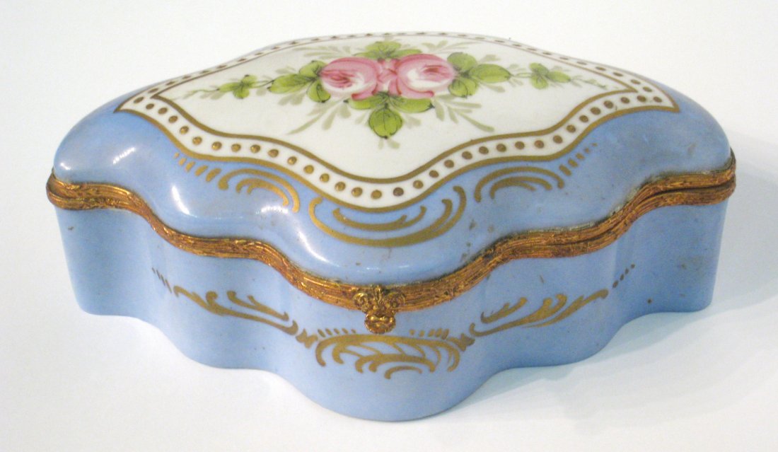 Satin Lined Porcelain Jewelry Box: Porcelain casement bound in brass with a padded golden satin interior. Shipping: We are able to pack and ship this item to an address in the United States for $25.00 via USPS Priority Mail. Tracking i