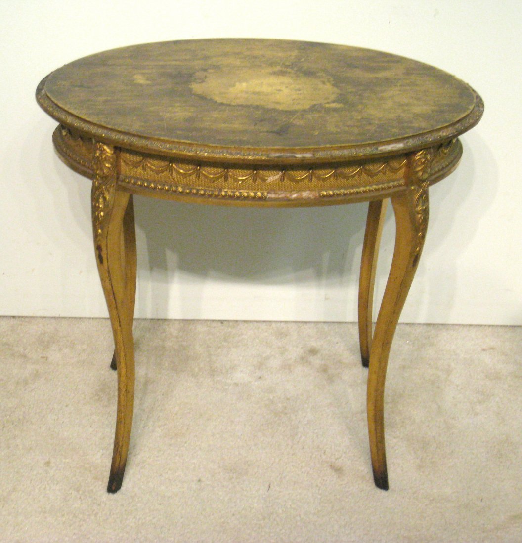 Oval Gold Table: A late 19th or early 20th Century gold leaf decorated table in distressed condition. . Shipping: We are unable to ship this item. Please contact our local UPS Store, store1152@theupsstore.com, for a q