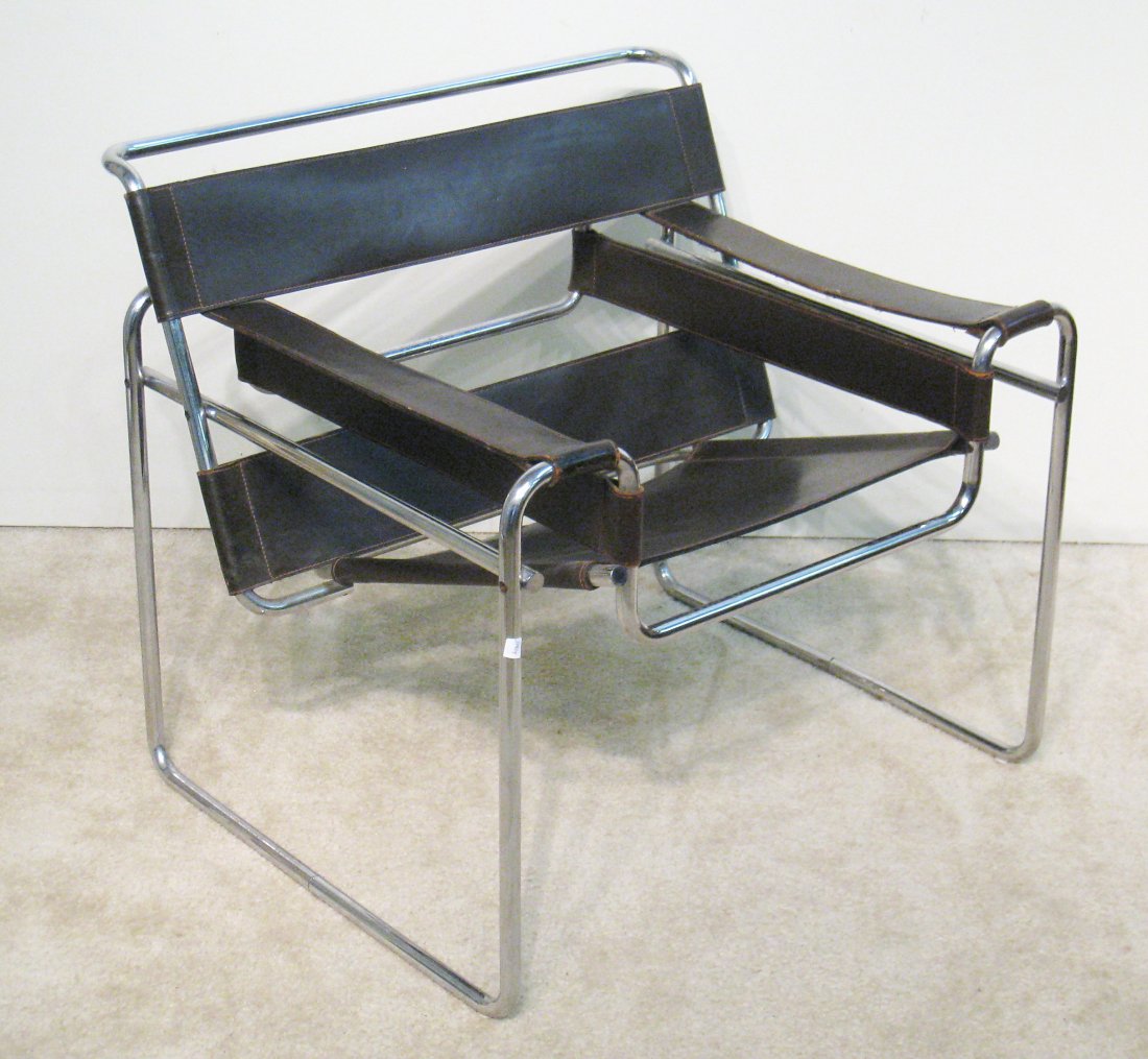 Marcel Breuer Wassily Moderne Era Chair: In dark leather with chrome plated tubular frame, 29"X 31" X 28". Designed in 1925 by Bauhaus designer Marcel Breuer, the folklore is that the "Wassily" chair takes its name from Bauhaus artist Wassil