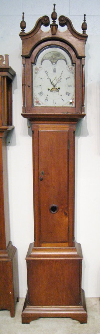 Hagerstown Tall Case Clock: An early Federal solid walnut tall case clock descended from a Maryland family, with possibly original finials, and a painted dial. The maker;s name is rubbed as is the town of creation, although sinc