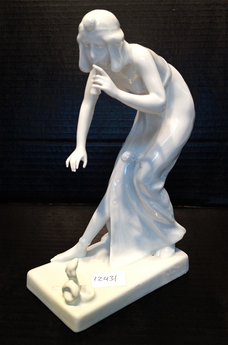 Rosenthal White Porcelain Figurine: A 7 3/4" early 20th century figurine of a lady snake charmer. Shipping: We are able to pack and ship this item to an address in the United States for $25.00 via USPS Priority Mail. Tracking informatio
