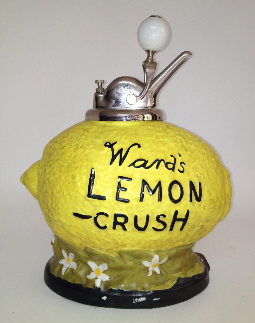 Ward's Lemon Crush Ceramic Jar: A 13 1/2" lemonade or lemon crush dispenser consisting of a porcelain 9 1/2" container with a steel pump. In very good- excellent condition, although possibly missing a bottom cap from the pump. Shipp