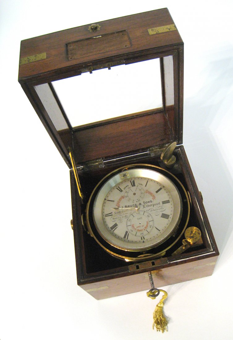 Chronometer by J. Bruce & Sons: A 19th century ships marine chronometer within a 7" two tiered mahogany brass bound glazed box. The silvered dial signed J. Bruce, South Castle, Liverpool, Makers to the Admiralty". Having a 56 hour c