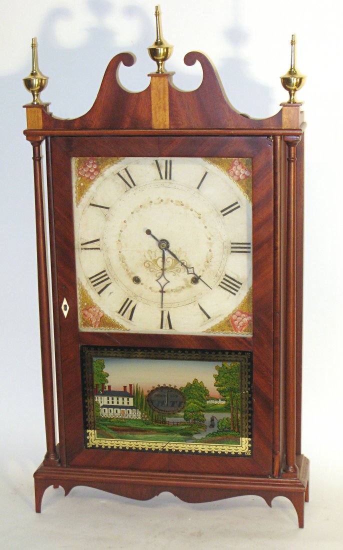 Terry Clock By Seth Thomas: A mahogany veneer so-called "Pillar and Scroll" clock with an interior label identifying Seth Thomas as the maker. The reverse painted glass is not original, and has a neat (in fact, not very noticeab