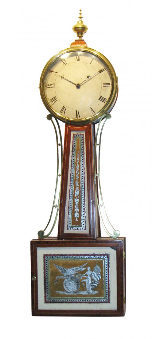 Banjo Timepiece Attr To Simon Willard: A 34" early banjo timepiece in the original "crossbanded" style, with a mahogany carcass all attributed to Simon Willard or his immediate circle, circa 1802-1805. The dial is infused with a bluish tin