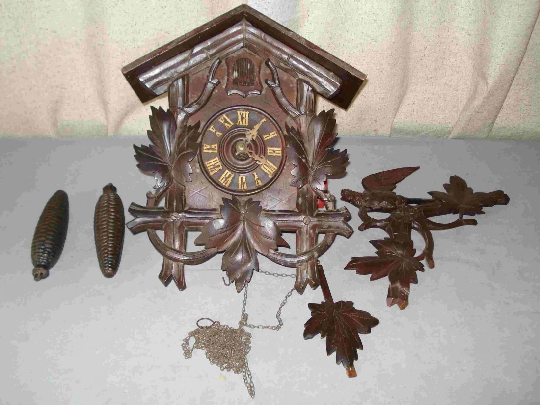 Carved Cuckoo Clock: An early 20th century well carved Black Forest Cuckoo clock, complete with weights, pendulum and carved crest. Shipping: We are able to pack and ship this item to an address in the United States for $
