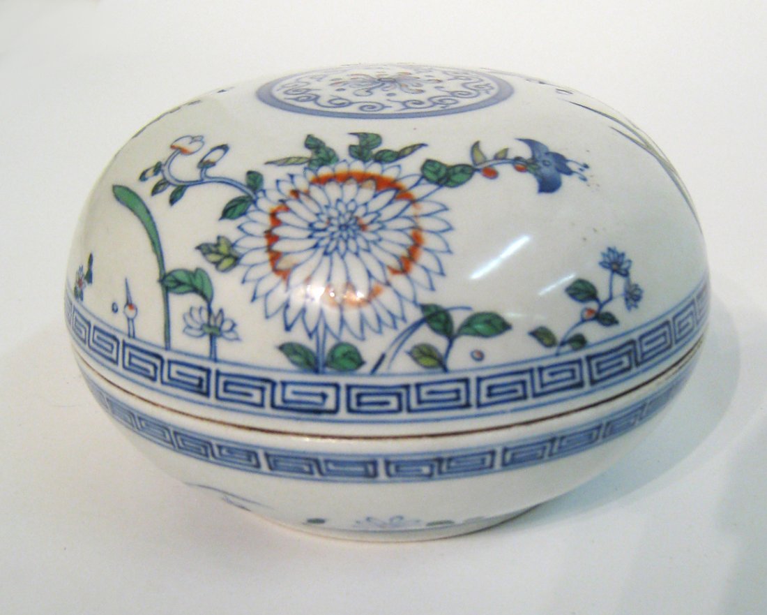 Chinese Antique porcelain candy box: In a lidded bowl like container form, 5 1/2" X 3 1/2" with multi-colored floral patterns flowing around. Shipping: We are able to pack and ship this item to an address in the United States for $40.00