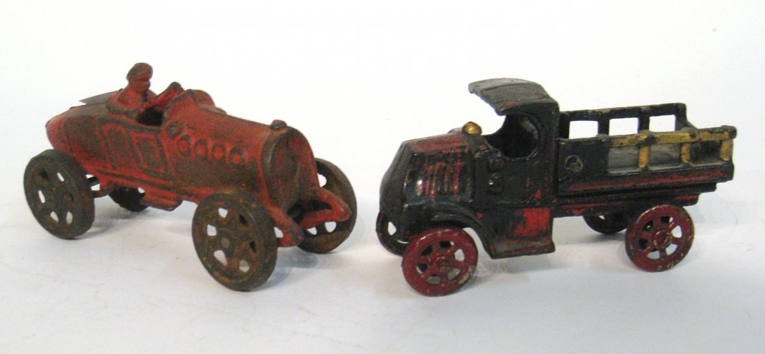 Two Cast Iron Toys: A racing car and delivery truck. Longest is about 5 1/2". Shipping: We are able to pack and ship this item to an address in the United States for $30.00 via USPS Priority Mail. Tracking information wi