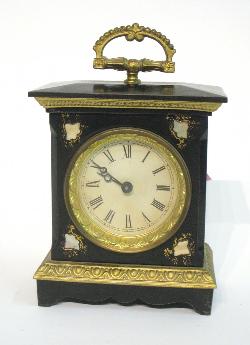 Desk Or Travel Clock: A, metal cased 8" clock with carrying handle. Shipping: We are able to pack and ship this item to an address in the United States for $25.00 via USPS Priority Mail. Tracking information will be sent t