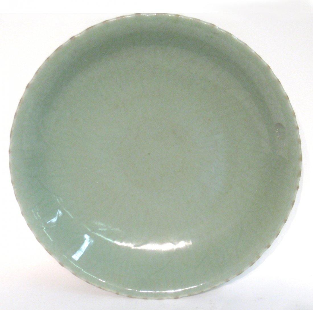 Chinese Celadon Glazed Charger: A 16 1/4" charger in jade green with an embossed lotus design beneath. Shipping: We are able to pack and ship this item to an address in the United States for $50.00 via USPS Priority Mail or via FedE