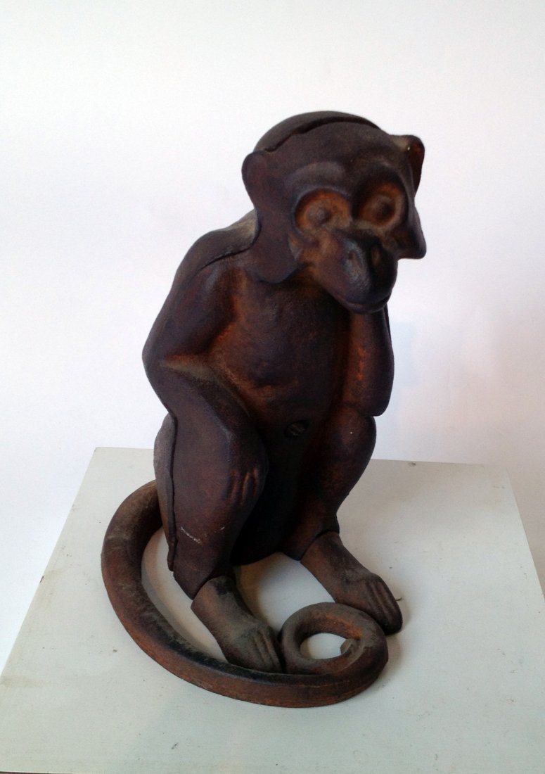Cast Iron Monkey: A seated monkey with a coiled tail. Instead of paint the surface is a gently rusted appearance to this savings bank. Shipping: We are able to pack and ship this item to an address in the United States