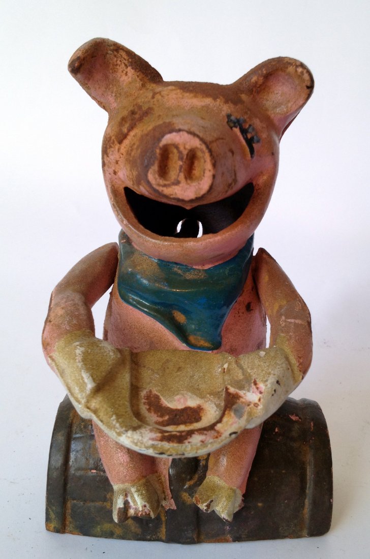 Cast Iron Bank: A Happy Pig Eats Coins: A painted cast iron mechanical pig who eats coins. Appears to have age. Shipping: We are able to pack and ship this item to an address in the United States for $25.00 via USPS Priority Mail. Tracking
