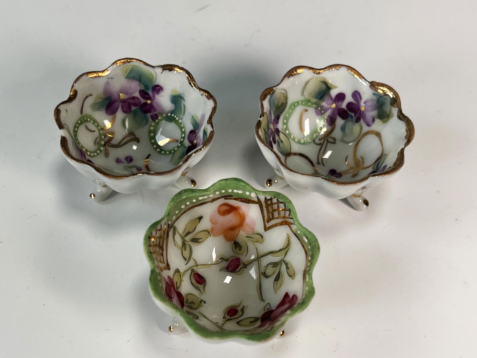 THREE SMALL TRIPOD HAND PAINTED PORCELAIN SALT CELLARS (1 of 3)