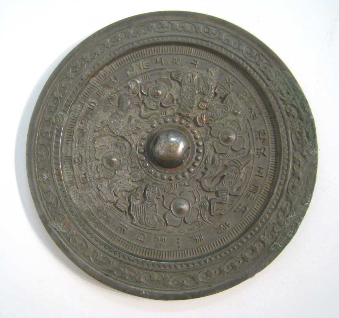 Bronze Mirror: 8 1/2" A Chinese 8 1/2" roundel convex mirror backed with a decorative bronze backing. Shipping: We are able to pack and ship this item to an address in the United States for $25.00 via USPS Priority