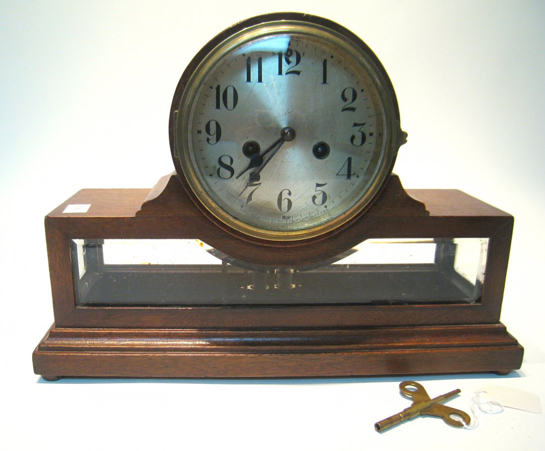 Mantel Clock By Waterbury: An unusual form of the bevel glass and brass mantel clocks, in a glass and mahogany case. This clock was the property of Forrest Guth, an original member of "Easy Company." To learn more about Mr. Gut