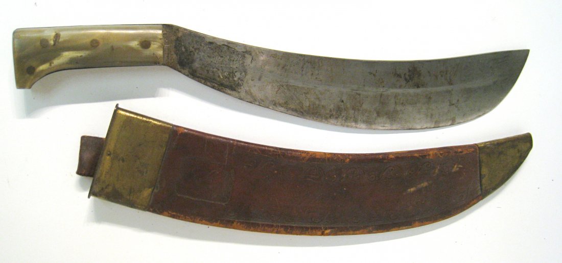 Steel Bladed Machete: A 20" machete with a bone handle and tooled leather scabbard marked "Collins & Co.". Shipping: We are able to pack and ship this item to an address in the United States for $30.00 via USPS Priority Ma