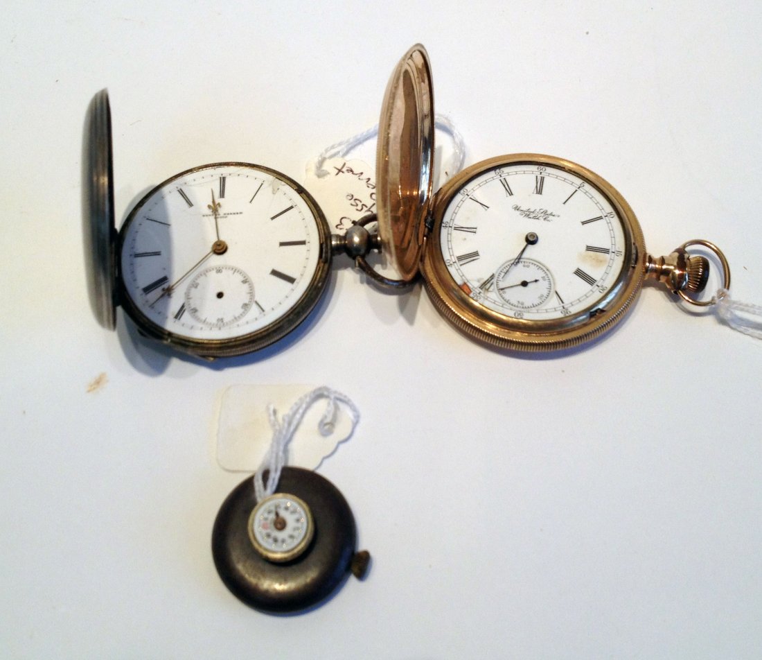Three Pocket Watches: United States Watch Co. within a gold filled case without crystal or hands; a sterling hunting cased watch lacking bezel; and a lapel watch missing hands and bezel and not running. Shipping: We are ab