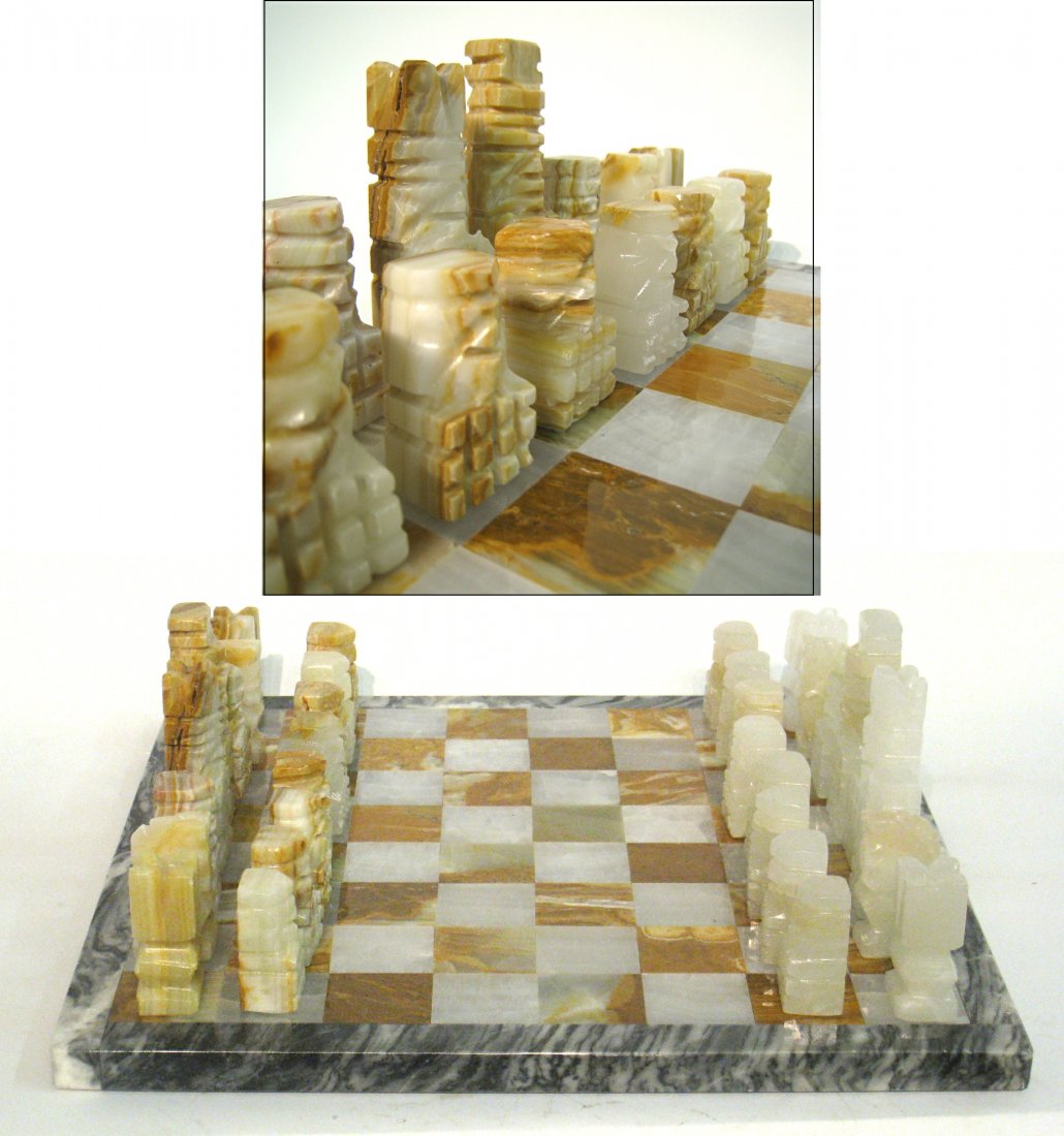 Chess Set: A carved hard stone chess set and board. 14 1/2" square. Shipping: We are able to pack and ship this item to an address in the United States for $55.00 via USPS Priority Mail or via FedEx Ground/Home