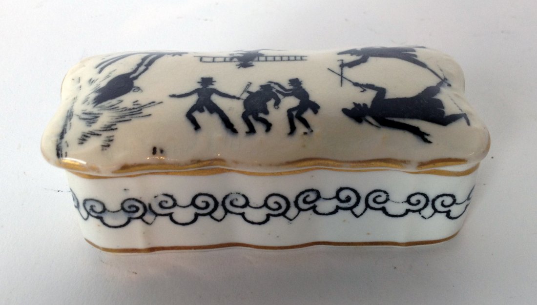 Ceramic Match Box: Similar to lot 133, an unusual 19th century lidded match box with striker inside the lid and decorated with black figures engaged in various acts. Shipping: We are able to pack and ship this item to a