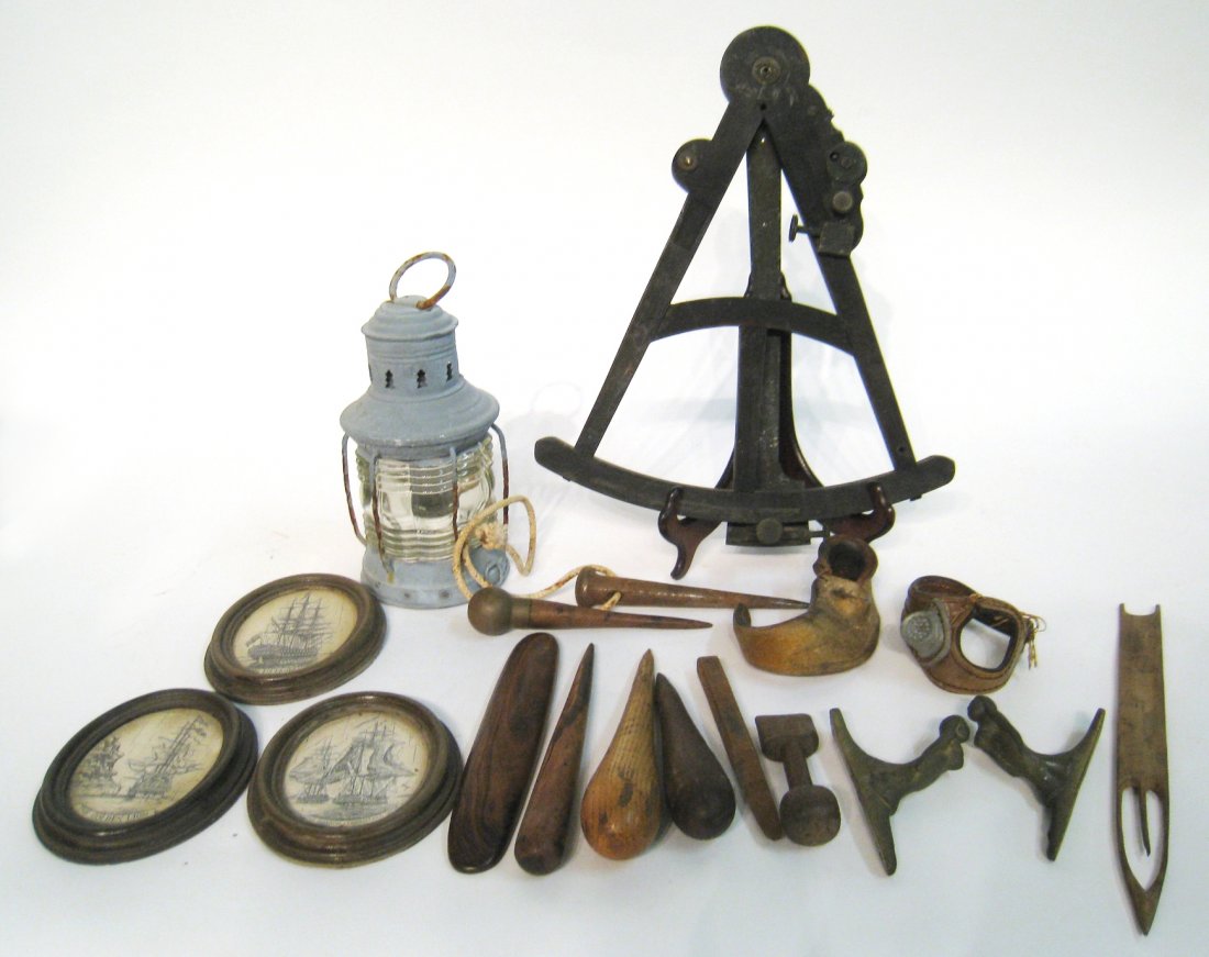Sailing Related Items: A box with sailing related tools, engraved scrimshawed hangings, and a damaged octant. About 12 items Shipping: We are able to pack and ship this item to an address in the United States for $50.00 via